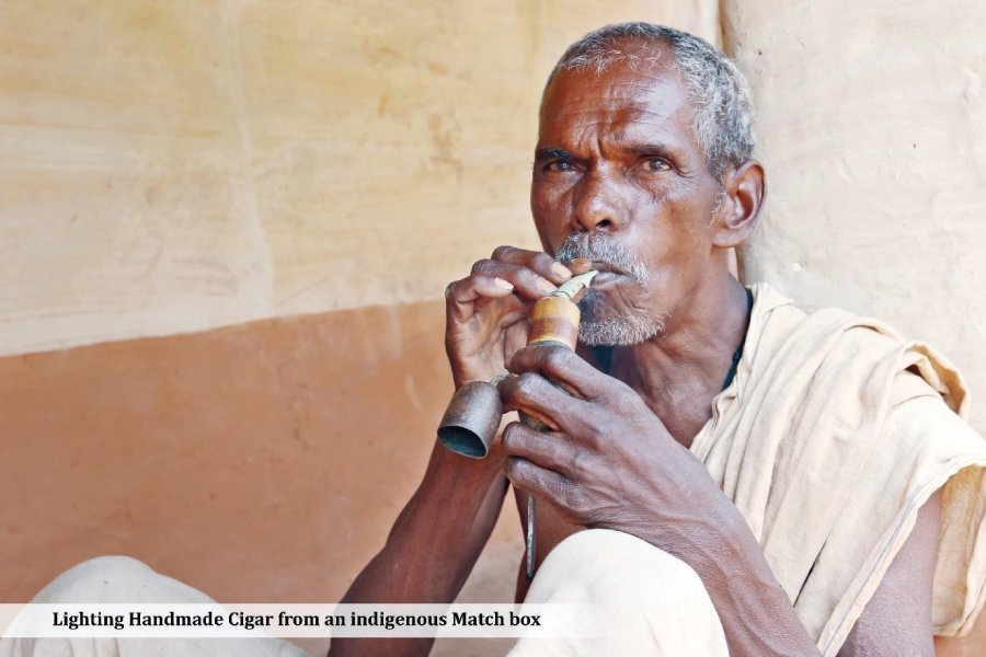 Lighting Handmade Cigar from an indigenous Match Box Lighting Handmade Cigar from an indigenous Match Box